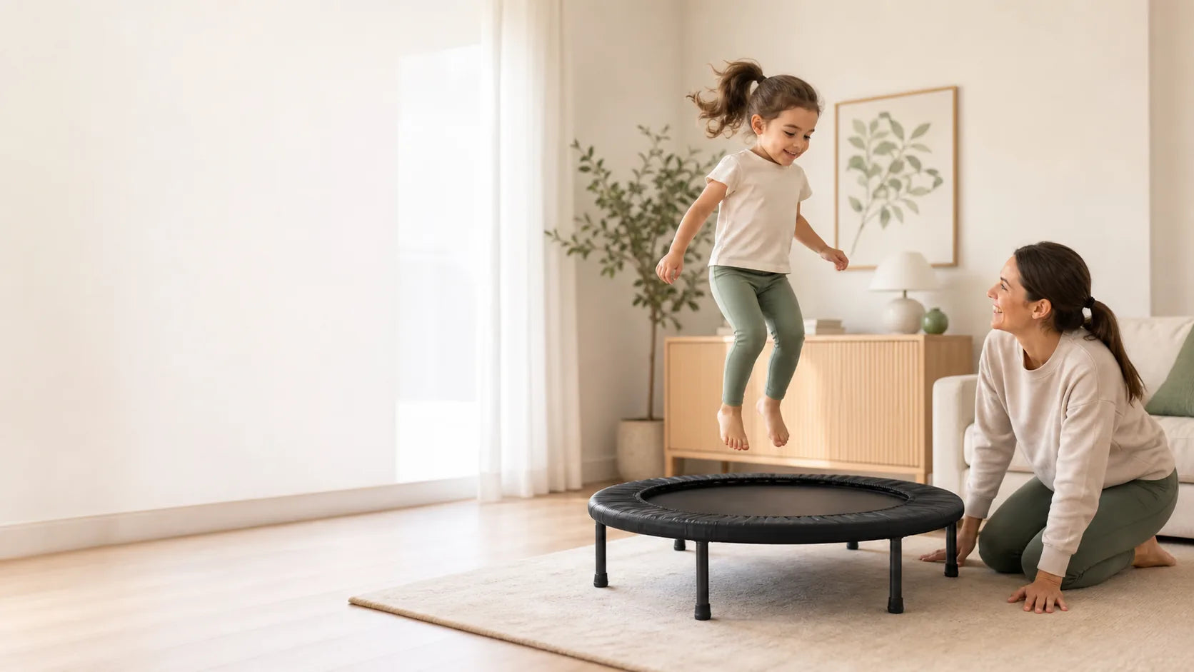 Adult supervising a child using a compact indoor trampoline in a bright family room